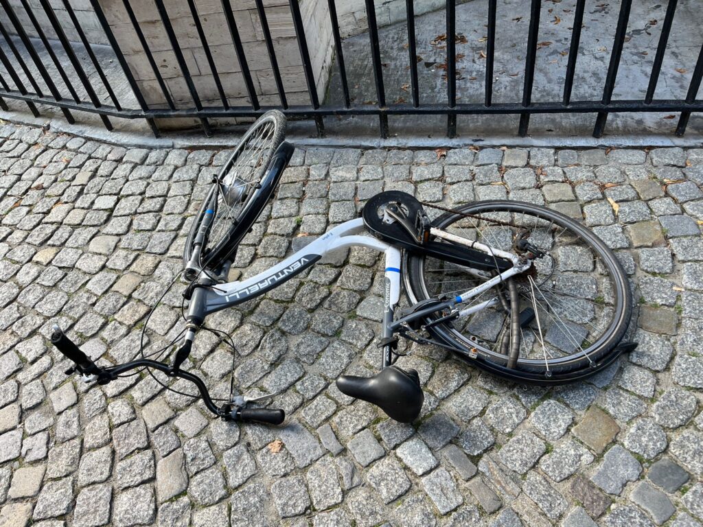 An old rusty bike next to a church
